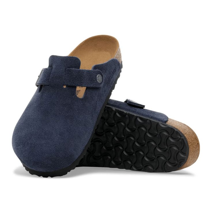 Navy blue suede clogs with cork sole on a white background