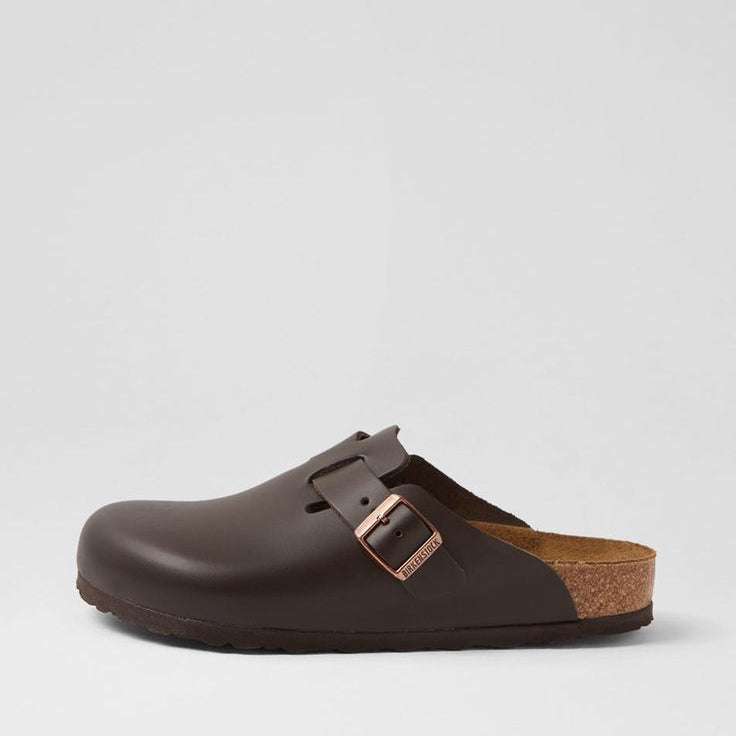 Brown clog shoe with cork sole on a light gray background