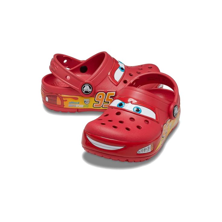 Red children's clogs with cartoon face design on a white background