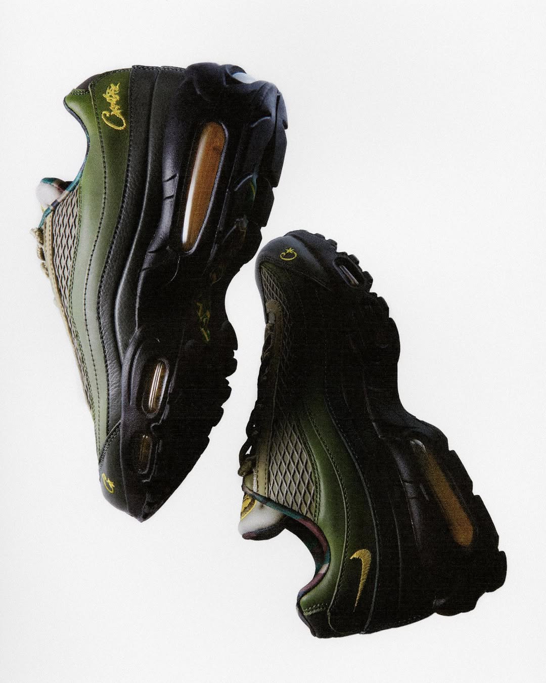 Black and green athletic shoes with brand logo on a white background