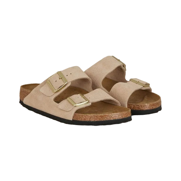 Pair of beige sandals with gold buckles on a white background