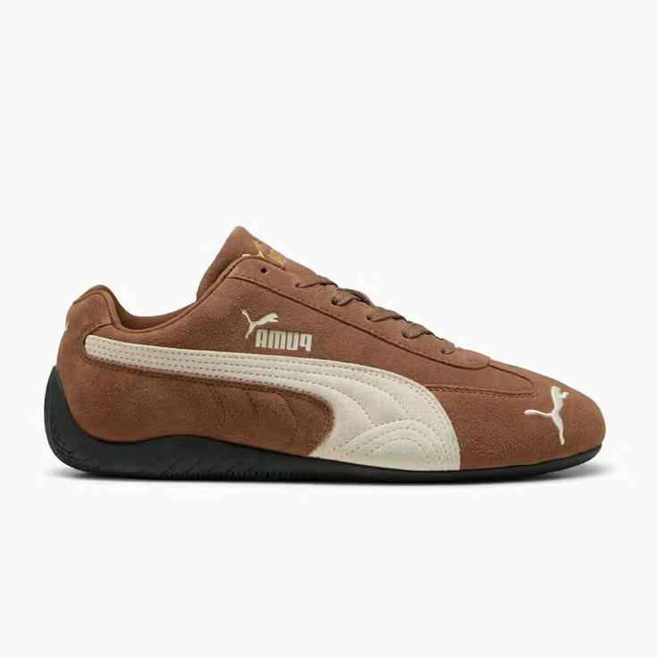 A Puma Samba sneaker in brown suede and beige leather with a black sole, shown from a side profile on a white background.