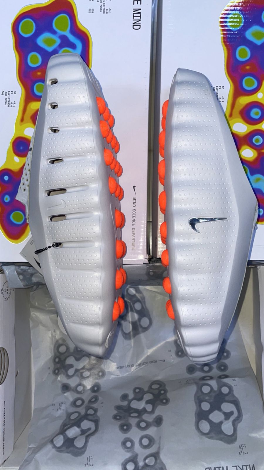White athletic shoes with a Nike logo on a colorful abstract background