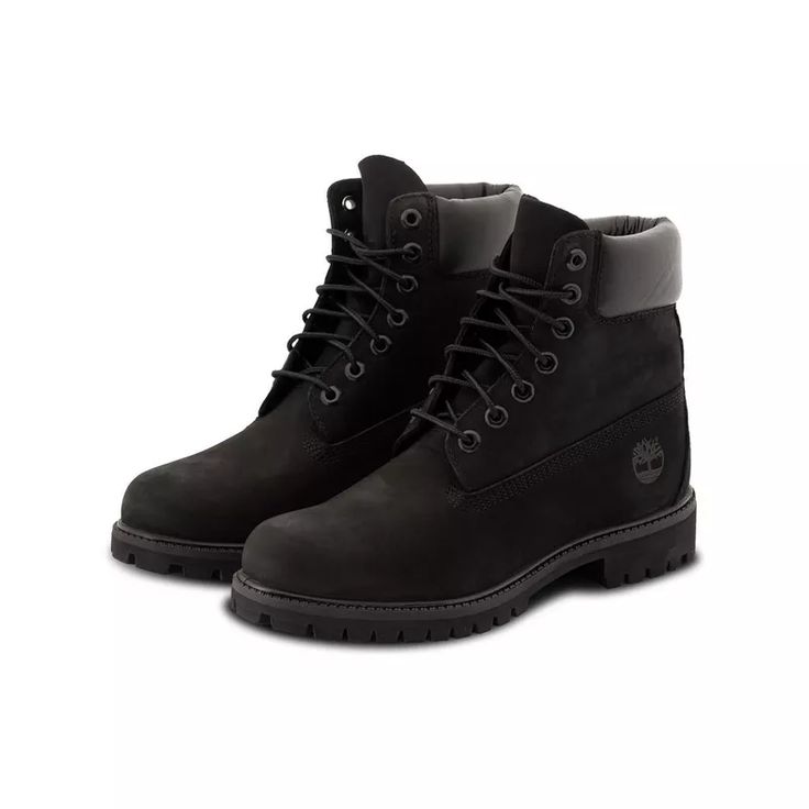 Black Timberland boots with gray lining on a white background