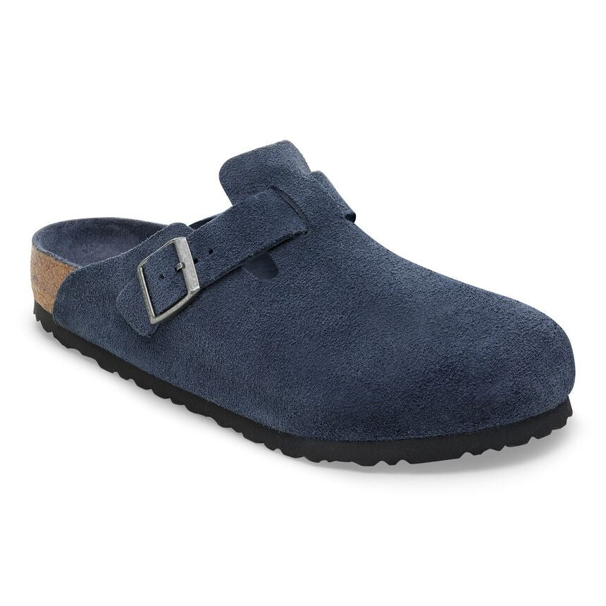 A single navy blue suede clog shoe with a silver buckle strap, set against a plain white background.