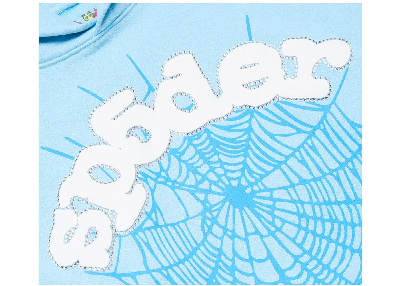 A close-up of a light blue Spider-Man themed garment featuring a large white 'spider' logo patch over a light blue spiderweb graphic.